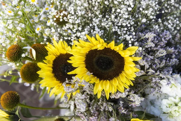 Yellow sunflowers, white daisies and daisies in a bouquet for birthdays and special occasions
