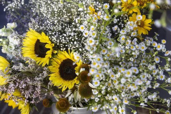 Yellow sunflowers, white daisies and daisies in a bouquet for birthdays and special occasions