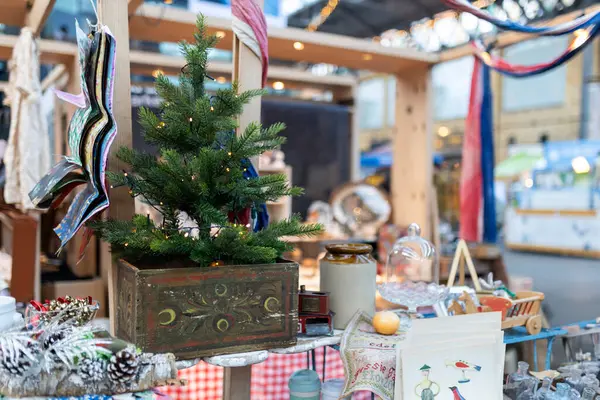 A beautifully styled booth at a craft fair, showcasing repurposed vintage items for sale.