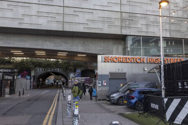 London, UK - December 4, 2024, Shoreditch High Street Overground Station with parked cars nearby clipart