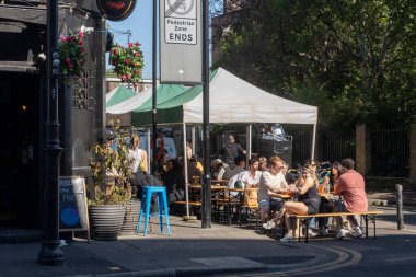 Londra, İngiltere, 10 Mayıs 2025, Londra 'daki Eagle Farringdon Pub' ın dışında müşteriler içkinin tadını çıkarıyor.
