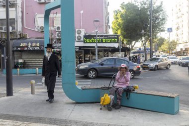 Petah Tikva, İsrail, 12 Haziran 2025 Petah Tikva 'da bir bankta dinlenen bir kadın..