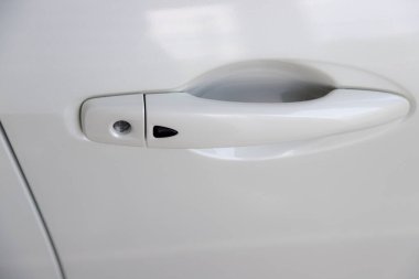 Color detail of a white car door - new car handle