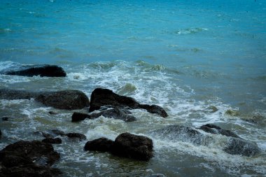 Waves on the seaside rocks are splashing on the rocks natural background