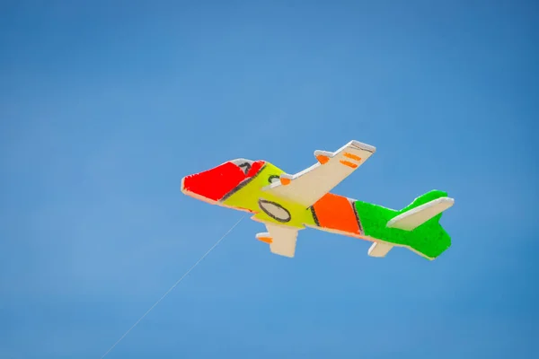The toy plane is made of colorful foam to catch the wind on the beach.