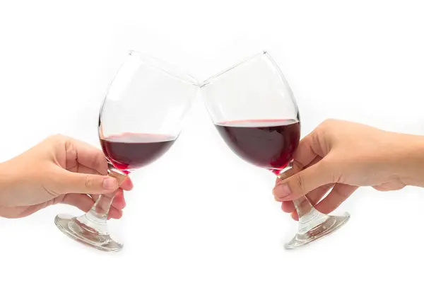 Cheer a glass of two red wine isolated on a white background.