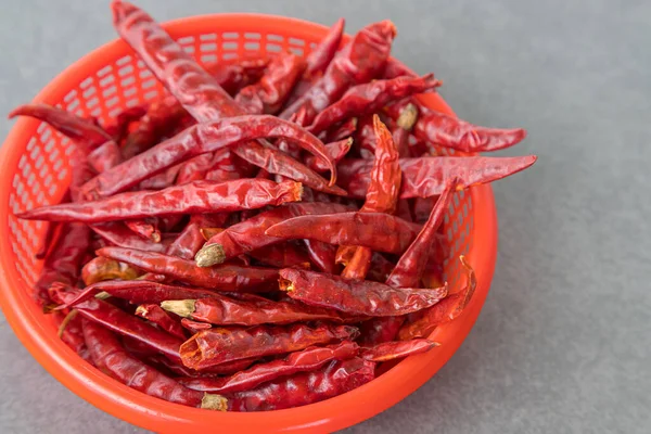 Dry chillies in the red bowl isolate gray background