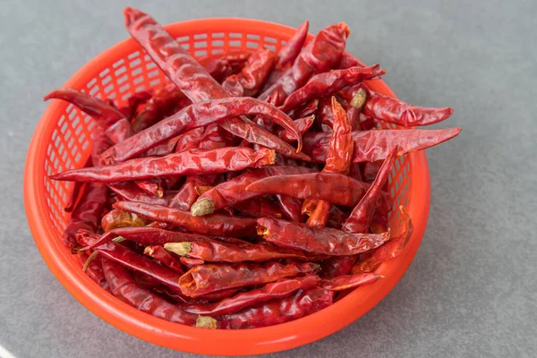 Dry chillies in the red bowl isolate gray background