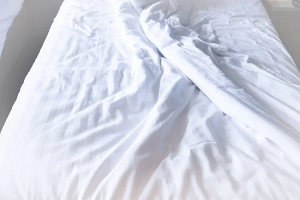 Bed and white sheets wrinkled after waking up
