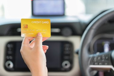 Driver paying with credit card isolated on car background