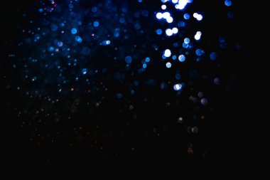 Kutlama arka planı için bulanık mavi bokeh 'in ışıldayan yıldızları