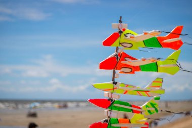 The toy plane is made of colorful foam to catch the wind on the beach.