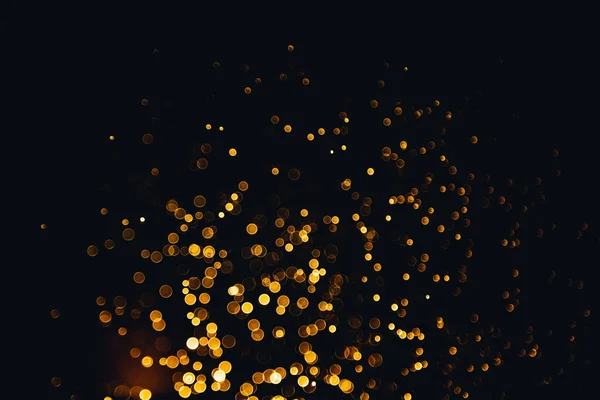 Abstract gold bokeh texture with black background