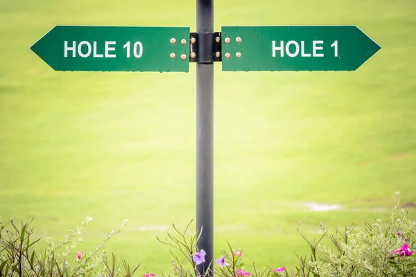 stock image Signs for the tee off at the golf course, hole 1 and hole 10 with flower nature background