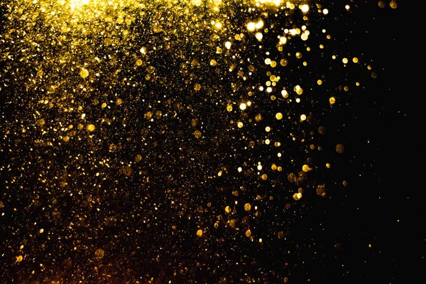 Arkaplanı kutlamak için bulanık altın bokeh yıldızlarını kullan