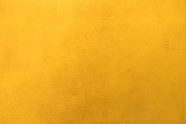 Gold paint on cement wall texture background