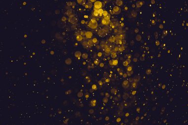 Siyah arkaplanda altın renkli ışıklar