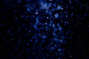 Kutlama arka planı için mavi Bokeh yıldızlarının parıltısı