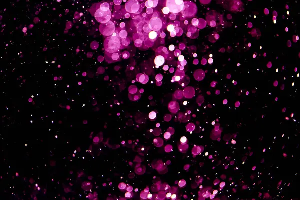 Vintage pink bokeh created by neon lights fwith black background