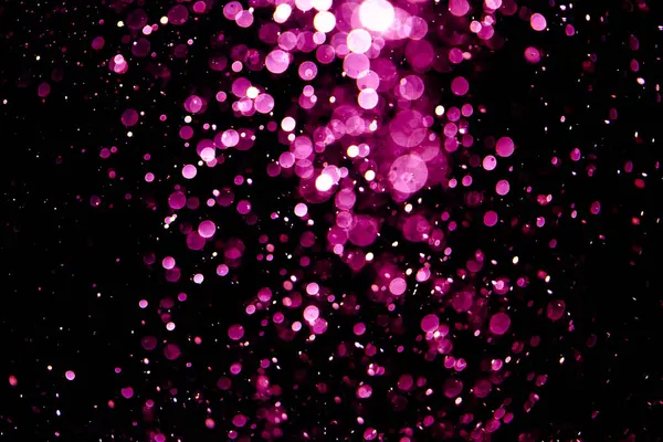 Vintage pink bokeh created by neon lights fwith black background