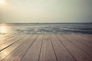 Vintage  wood floor extends into the sea when the water drops