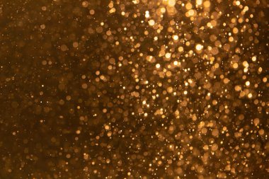 Arka plan için siyah kullanımda altın bokeh bulanıklığı giderici