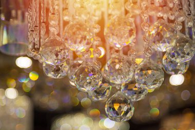 Güzel kristal avizeler. Sıcak ışık. Fırçalanmış cam kristallerin arasından yansıyan ışık.