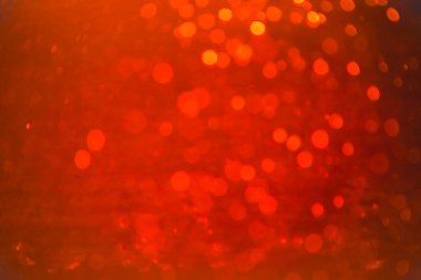 Siyah arkaplanlı kırmızı ışık desenli parıltı.