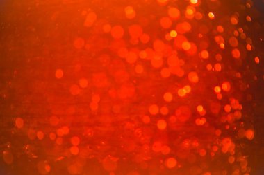 Siyah arkaplanlı kırmızı ışık desenli parıltı.