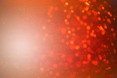 Siyah arkaplanlı kırmızı ışık desenli parıltı.