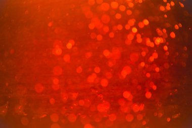 Siyah arkaplanlı kırmızı ışık desenli parıltı.