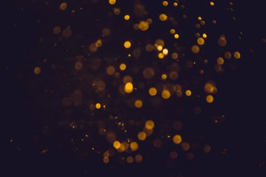 Altın bokeh, siyah arka planlı bulanık lüks
