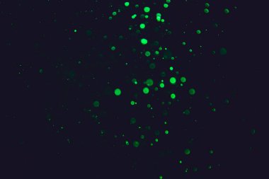 Siyah arkaplanı olan neon ışıkları tarafından oluşturulan klasik yeşil bokeh