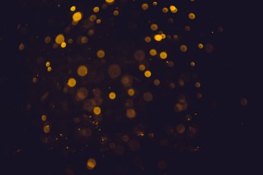Altın bokeh, siyah arka planlı bulanık lüks