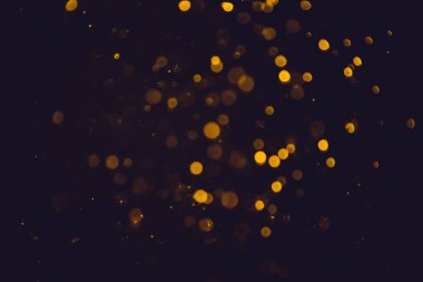 Altın bokeh, siyah arka planlı bulanık lüks