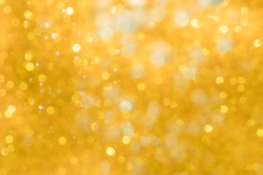 Altın soyut ışıltılar ya da parıltılı ışıklar Odaklanmamış daireler bokeh arkaplanı