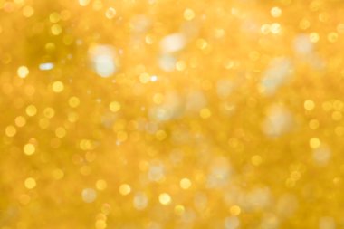 Altın soyut ışıltılar ya da parıltılı ışıklar Odaklanmamış daireler bokeh arkaplanı