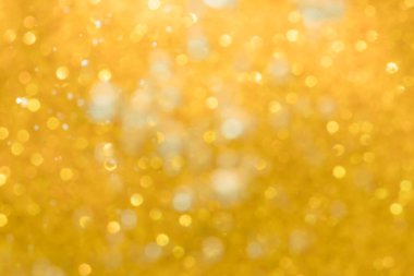 Altın soyut ışıltılar ya da parıltılı ışıklar Odaklanmamış daireler bokeh arkaplanı