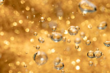 Altın soyut ışıltılar ya da parıltılı ışıklar Odaklanmamış daireler bokeh arkaplanı