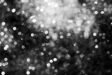 Siyah soyut ışıltılar ya da parıltılı ışıklar Odaklanmış daireler bokeh arkaplanı