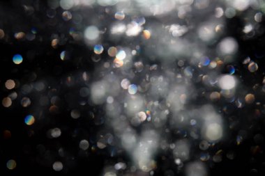 Siyah arkaplanda sudan gelen ışık bokeh