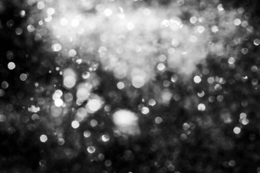 Siyah soyut ışıltılar ya da parıltılı ışıklar Odaklanmış daireler bokeh arkaplanı