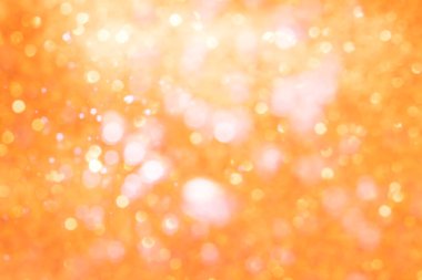 Turuncu soyut ışıltılar ya da parıltılı ışıklar Odaklanmamış daireler bokeh arkaplanı