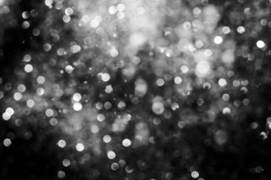 Siyah soyut ışıltılar ya da parıltılı ışıklar Odaklanmış daireler bokeh arkaplanı