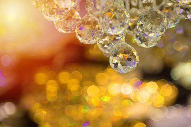 Güzel kristal avizeler. Sıcak ışık. Fırçalanmış cam kristallerin arasından yansıyan ışık.