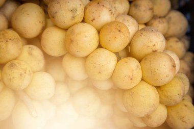 Longkong Thai fruit on sale in the market. clipart