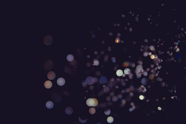 Defocus blur bokeh glitter gold vintage tone on black background clipart