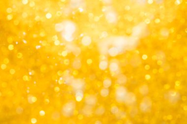 Altın soyut ışıltılar ya da parıltılı ışıklar Odaklanmamış daireler bokeh arkaplanı