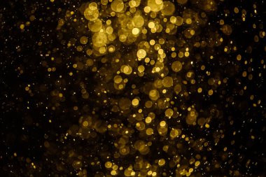 Görünür altın noktalı bulanık fotoğraf ışıl ışıl parlıyor. Duvar kağıdı olarak kullanılabilecek kadar lüks görünüyor.