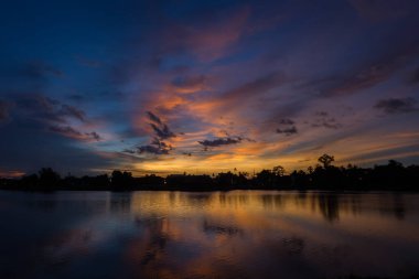 Nature silhouette twilight sky on lagoon with light reflection use for background clipart